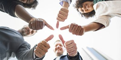 Business people giving a thumbs up